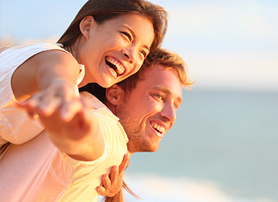 Couple showing engagement ring outdoors