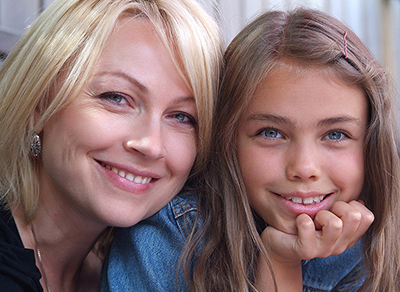 Mother and daughter smiling at camera