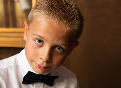 Boy wearing a bow tie looking straight into the camera