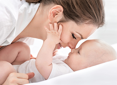 Mother kissing her baby
