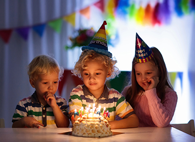 Children enjoying a birthday cake