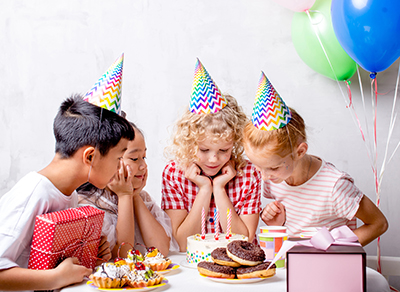Children in anticipation of a birthday cake