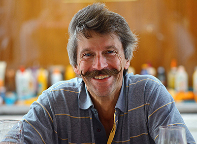 Outdoor portrait of an artist with funny moustache