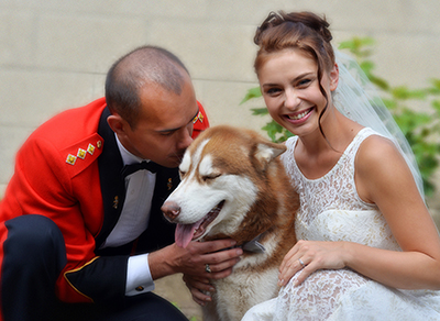 Bride and groom with a friendly dog