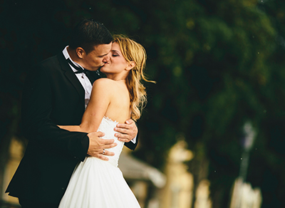 Bride and groom kissing in the park