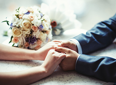 Bride and groom holding hands