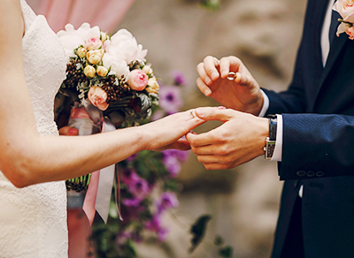 Newlyweds exchanging rings at the ceremony